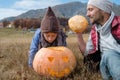 Cute boy in hat with father and Halloween Carved Pumpkin on the