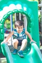 Cute boy is having fun with slider playing. Royalty Free Stock Photo