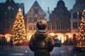 Cute boy having wonderful time on traditional Christmas market on winter evening. A child enjoying himself at Christmas fair