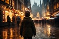 Cute boy having wonderful time on traditional Christmas market on winter evening. A child enjoying himself at Christmas fair