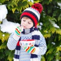 Cute boy holding big cup and hot chocolate drink and marshmallo Royalty Free Stock Photo