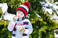 Cute boy holding big cup and hot chocolate drink and marshmallo Royalty Free Stock Photo