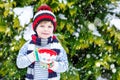 Cute boy holding big cup and hot chocolate drink and marshmallo Royalty Free Stock Photo