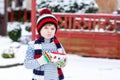 Cute boy holding big cup and hot chocolate drink and marshmallo Royalty Free Stock Photo