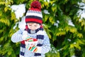 Cute boy holding big cup and hot chocolate drink and marshmallo Royalty Free Stock Photo