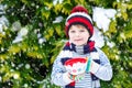 Cute boy holding big cup and hot chocolate drink and marshmallo Royalty Free Stock Photo