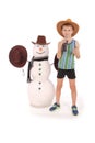 Cute boy holding a cola bottle near a snowman with scarf and hat Royalty Free Stock Photo