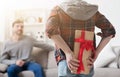 Cute boy holding gift for father behind his back Royalty Free Stock Photo