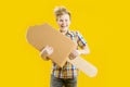 A cute boy is holding a huge ice cream on a stick in his hands. A guy with a funny face. Confectionery.