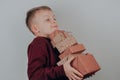 Cute boy holding Organic Christmas Presents.