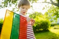 Cute boy holding tricolor Lithuanian flag on Lithuanian Statehood Day, Vilnius, Lithuania