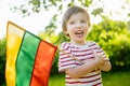 Cute boy holding tricolor Lithuanian flag on Lithuanian Statehood Day, Vilnius, Lithuania