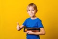 Cute boy holds abacus. Kid study at mental arithmetic school