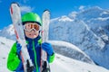 Cute boy hugging ski over mountains portrait Royalty Free Stock Photo