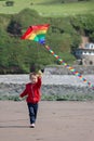 Cute boy with kite on the beach Royalty Free Stock Photo