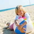 Cute boy laying on beach ball. Royalty Free Stock Photo