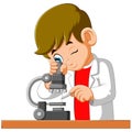 Cute boy looking through a microscope Royalty Free Stock Photo