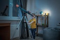 Cute boy is looking through a telescope at the night starry sky. Children`s scientific hobbies and space exploration Royalty Free Stock Photo