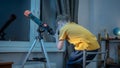 Cute boy is looking through a telescope at the night starry sky. Children`s scientific hobbies and space exploration Royalty Free Stock Photo