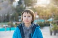 Cute preschool boy, child playing on the beach, making funny faces, springtime on sunset Royalty Free Stock Photo