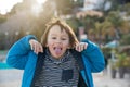 Cute preschool boy, child playing on the beach, making funny faces, springtime on sunset Royalty Free Stock Photo