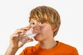 Cute boy with orange shirt drinks water Royalty Free Stock Photo