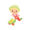 Cute Boy in Overalls, Rubber Boots and Hat Pushing Wheelbarrow, Young Farmer Cartoon Character Engaged in Agricultural Royalty Free Stock Photo