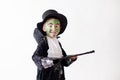 Cute boy with painted face as a a magician and dressed in magician costume, having fun Royalty Free Stock Photo