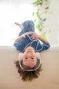 Cute boy with phone and head phones, listening music Royalty Free Stock Photo