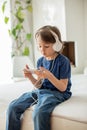 Cute boy with phone and head phones, listening music Royalty Free Stock Photo