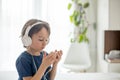 Cute boy with phone and head phones, listening music Royalty Free Stock Photo