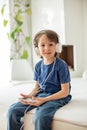 Cute boy with phone and head phones, listening music Royalty Free Stock Photo