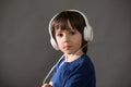 Cute boy with phone and head phones, listening music Royalty Free Stock Photo