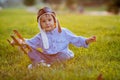 Cute boy, playing with airplane on sunset in the park Royalty Free Stock Photo