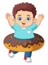 A cute boy playing with a big chocolate donut toy Royalty Free Stock Photo