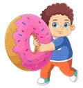 A cute boy playing with a big pink donut toy Royalty Free Stock Photo