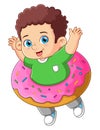 A cute boy playing with a big strawberry donut toy Royalty Free Stock Photo