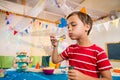 Cute boy playing with bubble wand during birthday party Royalty Free Stock Photo