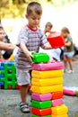 Cute boy playing with buiding toy colorful blocks. Kid with happy face playing with plastic bricks. Plastic Large Toy