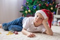 Cute boy, playing with cars in living room in front of Christmas Royalty Free Stock Photo