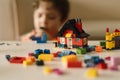 Cute boy is playing constructor at home. Kid playing block toys in home at nursery. Royalty Free Stock Photo