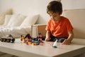 Cute boy is playing constructor at home. Kid playing block toys in home at nursery. Royalty Free Stock Photo