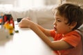 Cute boy is playing constructor at home. Kid playing block toys in home at nursery. Royalty Free Stock Photo