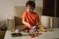 Cute boy is playing constructor at home. Kid playing block toys in home at nursery. Royalty Free Stock Photo