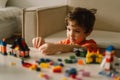 Cute boy is playing constructor at home. Kid playing block toys in home at nursery. Royalty Free Stock Photo