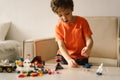 Cute boy is playing constructor at home. Kid playing block toys in home at nursery. Royalty Free Stock Photo