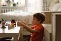 Cute boy is playing constructor at home. Kid playing block toys in home at nursery. Royalty Free Stock Photo