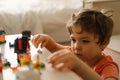 Cute boy is playing constructor at home. Kid playing block toys in home at nursery. Royalty Free Stock Photo