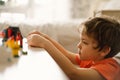 Cute boy is playing constructor at home. Kid playing block toys in home at nursery. Royalty Free Stock Photo