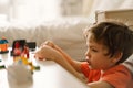 Cute boy is playing constructor at home. Kid playing block toys in home at nursery. Royalty Free Stock Photo